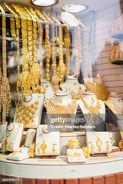 jewellery in shop window at gold market - gold hoop earring stockfoto's en -beelden