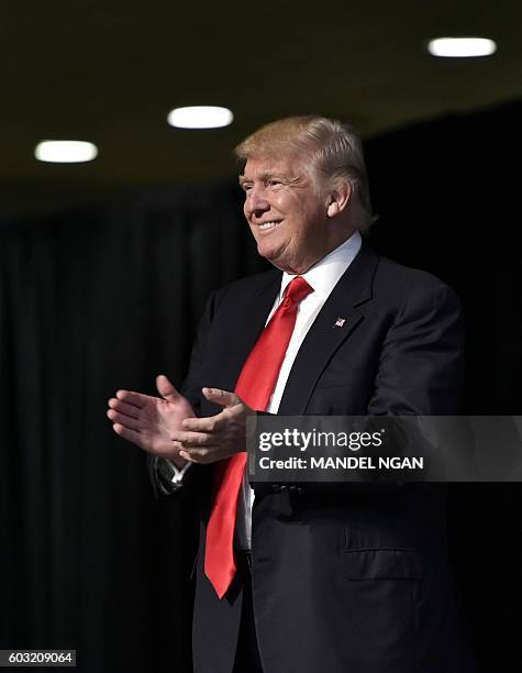 Republican presidential nominee Donald Trump arrives on stage to address the 138th General Conference of National Guard Association of the US at the...