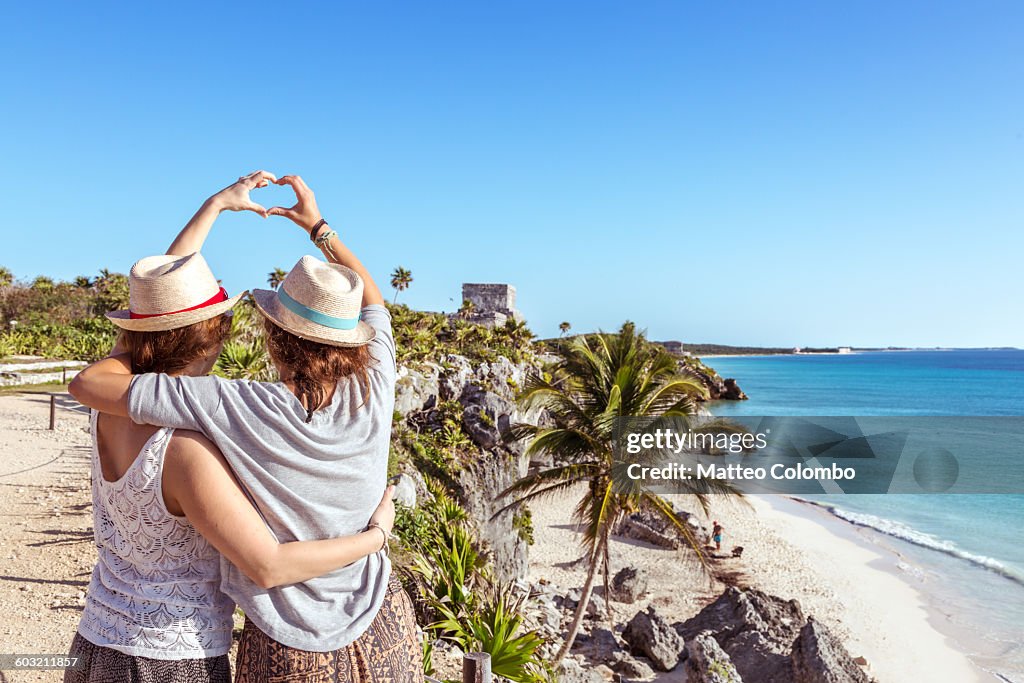 Female couple doing a heart sign, Tulum, Mexico