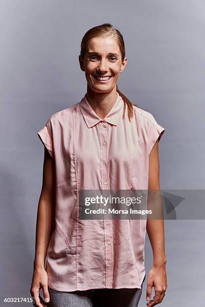 portrait of smiling mature woman - pink collared shirt stock pictures, royalty-free photos & images