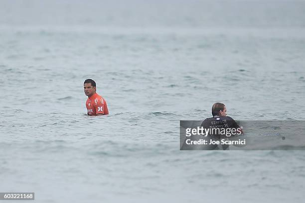 Michel Bourez of Tahiti and Brett Simpson of USA wait for waves during a lull in the fifth round heat at 2016 Hurley Pro at Trestles at San Onofre...