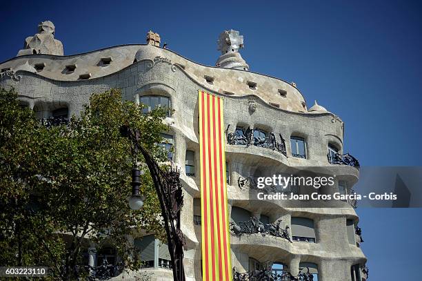 Catalonian flag is hung from La Pedrera designed by Antoni Gaudí, showing a Catalonia's flag during the Catalonia National Day "La Diada" on...