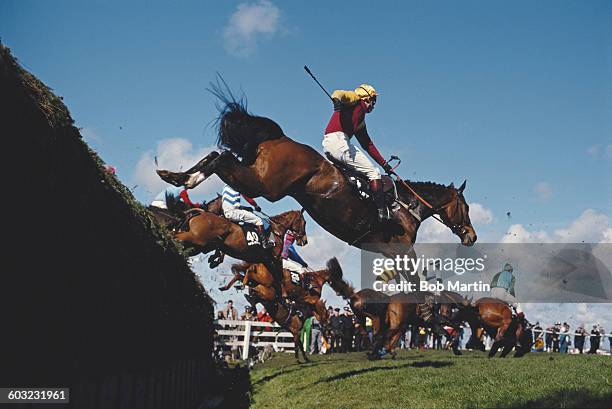 Generic view of horses and jockeys jumping Becher's Brook during the143rd running of the Seagram Grand National horse race on 8 April 1989 at the...