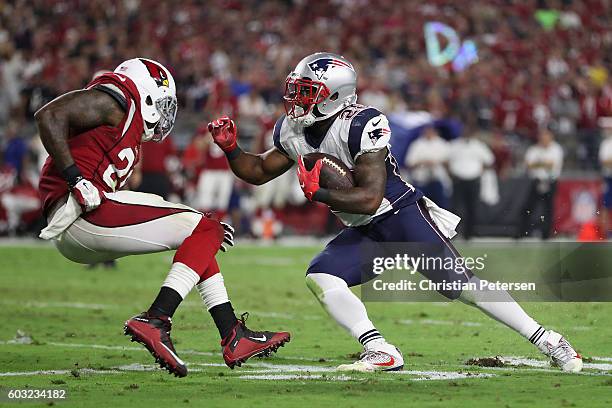 Running back James White of the New England Patriots runs with the football against the Arizona Cardinals during the NFL game at the University of...