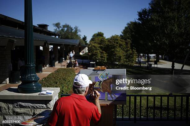 An artist paints a picture of Triple Crown winner American Pharoah during the 2016 September Yearling Sale at Keeneland Racecourse in Lexington,...