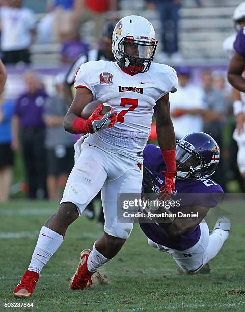 George Moreira of the Illinois State Redbirds runs for a first down on the final drive of the game grabbed by Kyle Queiro of the Northwestern...