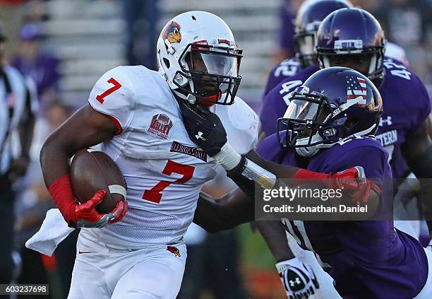 George Moreira of the Illinois State Redbirds runs for a first down on the final drive of the game grabbed by Kyle Queiro of the Northwestern...