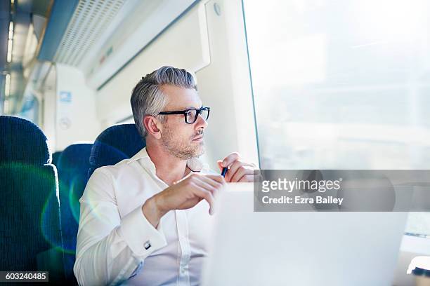 businessman brainstorming while on a train. - bart zug stock-fotos und bilder