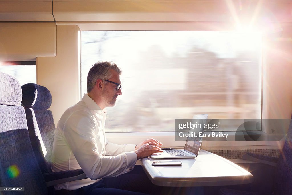 Businessman working on a commuter train.