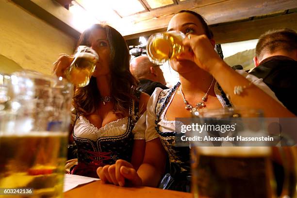 Women dressed in traditional Bavarian clothing Dirndl attend the annual beer tasting prior to the2016 Oktoberfest in the cellar of the Munich Beer...