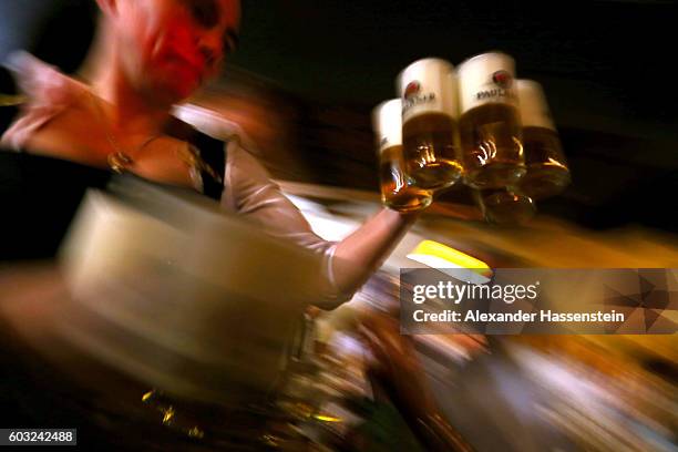 Waitress brings glasses of beer to the heads of the six Munich breweries as well as the owners of the Oktoberfest tents for the annual beer tasting...