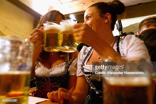 Women dressed in traditional Bavarian clothing Dirndl attend the annual beer tasting prior to the2016 Oktoberfest in the cellar of the Munich Beer...