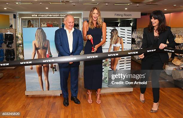 Elle Macpherson cuts the ribbon as Simon De Winter and Gillian Ridley Whittle look on during the launch of "Elle Macpherson Body" at Myer Sydney on...
