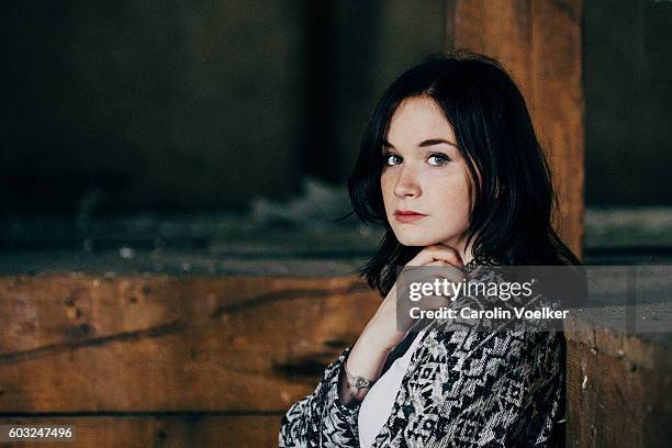 young woman with dark hair and pale skin skiming her neck - pale complexion fotografías e imágenes de stock