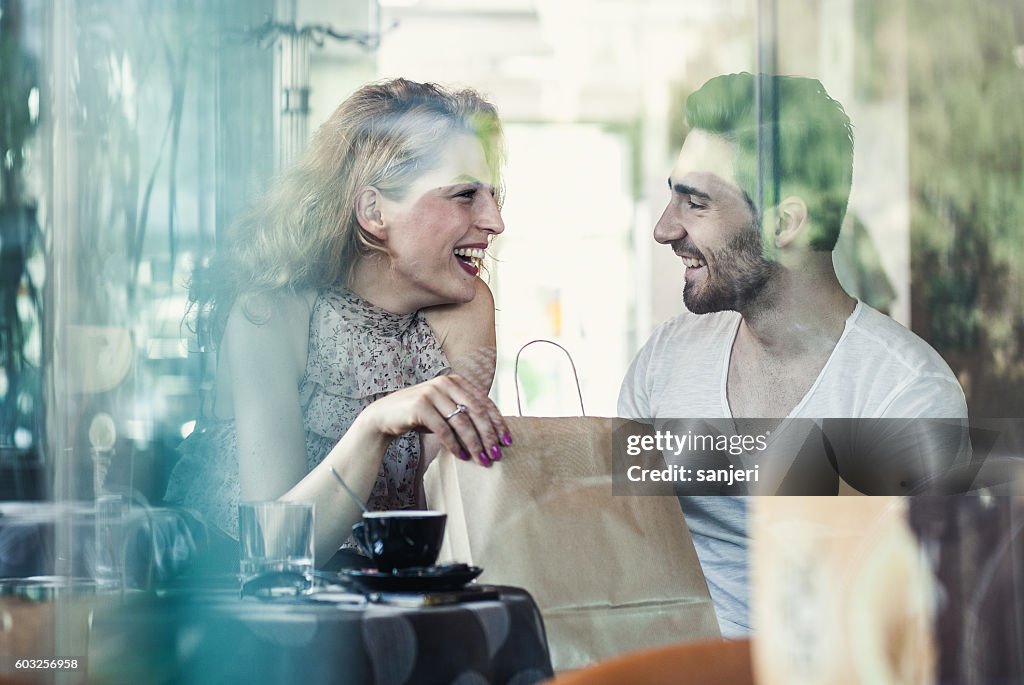 Young Couple Sitting in a Cafe Chatting
