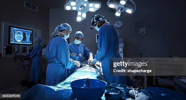 they diligently stay current in a very complicated field - chirurgie stockfoto's en -beelden