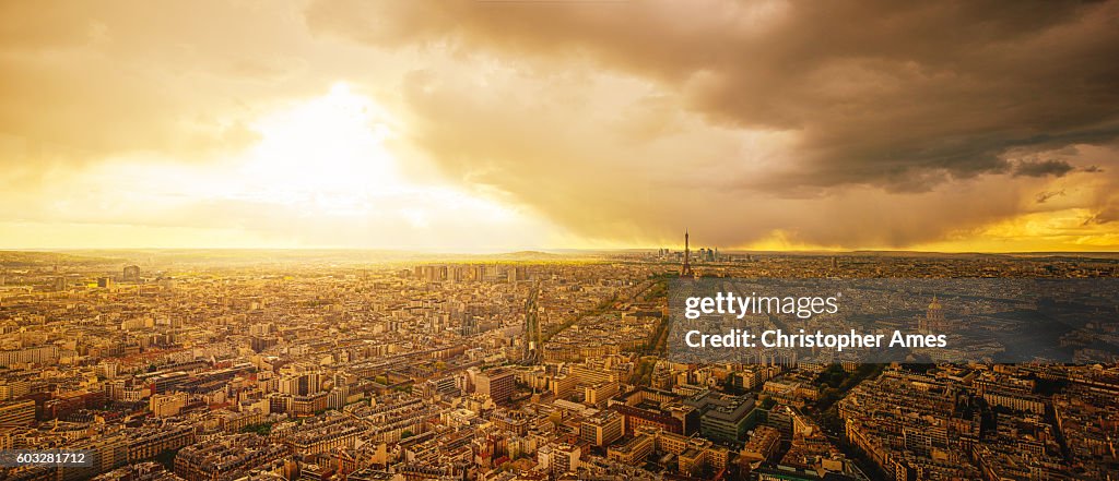 Aerial View of Paris at Sunset with Dramatic Storm Clouds