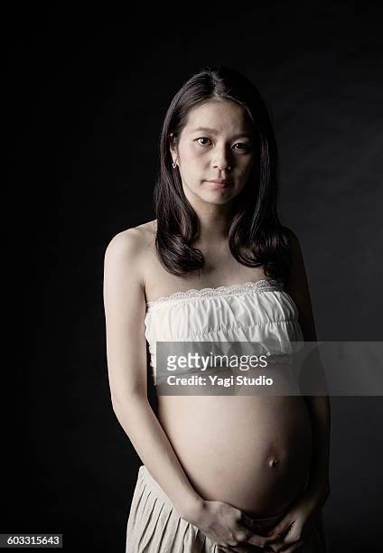 portrait of pregnant woman - woman black background stock pictures, royalty-free photos & images