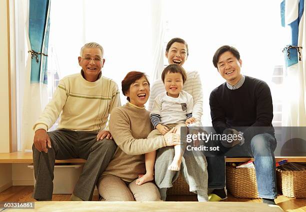 portrait of three generations family - couple jeans shirt stock-fotos und bilder