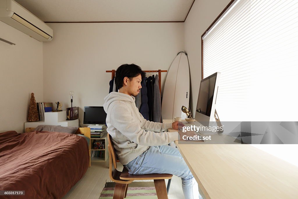 Young man using computer at desk