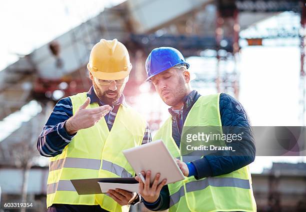 responsible manager having discussion on construction site - bridge built structure stock pictures, royalty-free photos & images