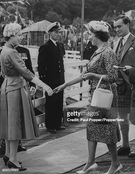 Queen Elizabeth II bids goodbye to John Crichton-Stuart, 6th Marquess of Bute and his wife Beatrice Weld-Forester following a trip to Rothesay, Bute...
