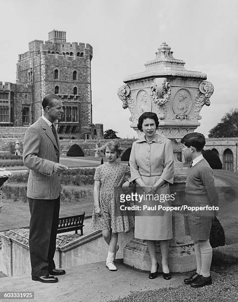 Queen Elizabeth II with Prince Philip, Duke of Edinburgh and their children, Princess Anne and Prince Charles, on the top of the East Terrace Garden...