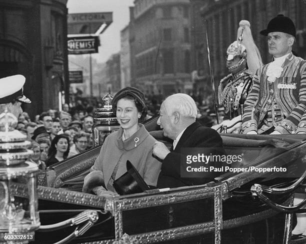 Queen Elizabeth II and President of the Federal Republic of Germany, Theodor Heuss ride together in the state carriage in a procession from Victoria...