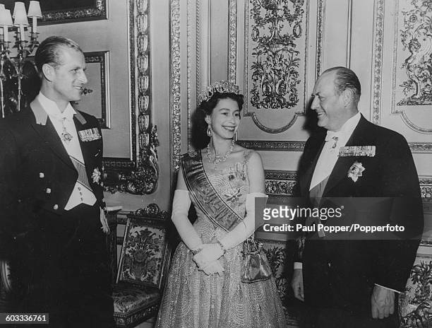 Queen Elizabeth II and Prince Philip, Duke of Edinburgh talk with King Olav V of Norway following the King's investiture as a Knight Companion of the...