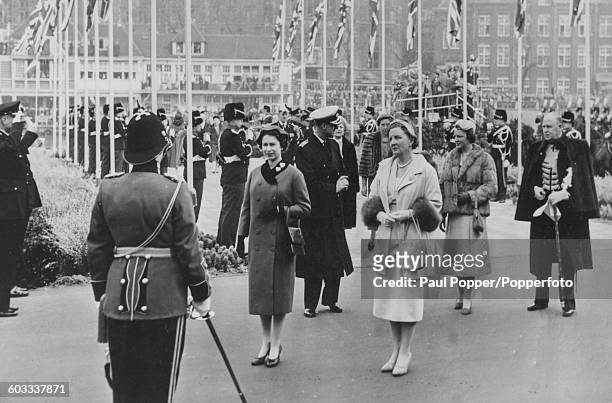 Queen Elizabeth II of Great Britain stands with Queen Juliana of the Netherlands, with Prince Philip and Princess Irene in the background as they...