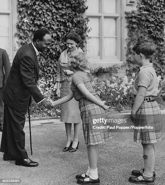 Kwame Nkrumah, Premier of Ghana, shakes hands with Princess Anne and Prince Charles as their mother, Queen Elizabeth II looks on at Balmoral,...