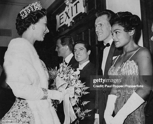 Queen Elizabeth II meets with American singer Eartha Kitt along with a line-up of stars including American singer Pat Boone, Spanish dancer Antonio...