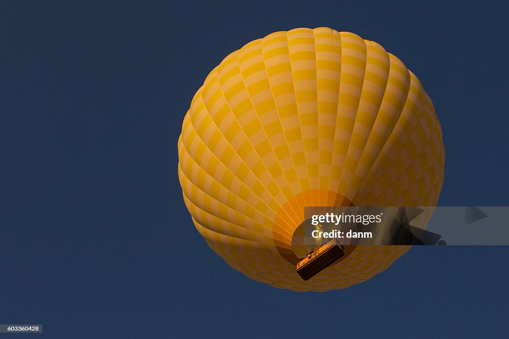 Yellow balloon in the blue sky. Cappadocia, Turkye