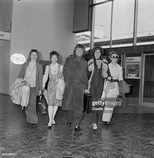 English entertainer Tommy Steele witha troupe of dancers at London Airport, bound for Las Vegas, 13th February 1971. The dancers are Michele Hardy,...