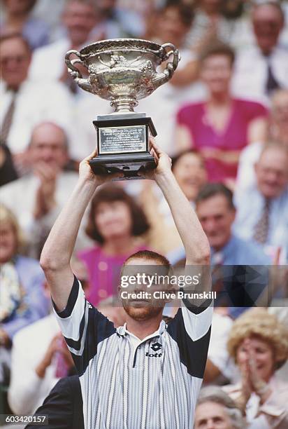Boris Becker of Germany holds aloft the trophy after the Men's Singles Final of the Australian Open on 28 January 1996 in Flinders Park, Melbourne,...