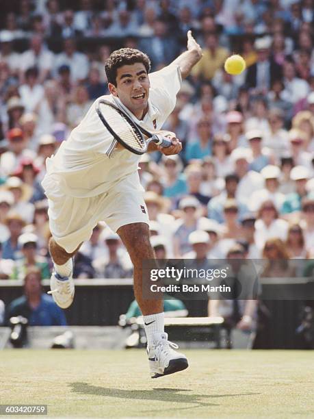 Pete Sampras of the United States reaches to make a return during the Men's Singles Semi Final of the Wimbledon Lawn Tennis Championship against Todd...