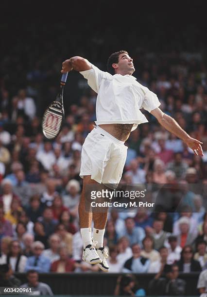 Pete Sampras of the United States reaches to make a jumping overhead return against Goran Ivanisevic during the Men's Singles Final of the Wimbledon...
