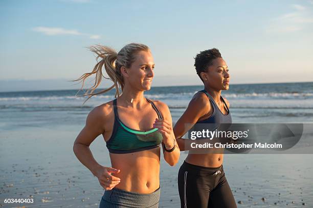 female friends go for run at the beach - beach black and white stock pictures, royalty-free photos & images