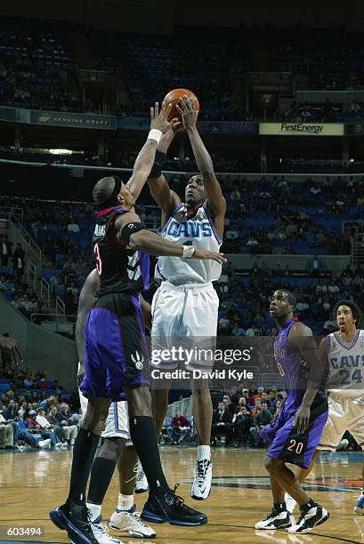 Guard Wesley Person of the Cleveland Cavaliers shoots over forward Jerome Williams of the Toronto Raptors during the NBA game at Gund Arena in...