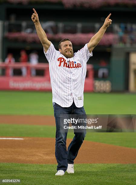 Wrestler Daniel Bryan reacts after throwing out the first pitch prior to the game between the Pittsburgh Pirates and Philadelphia Phillies at...