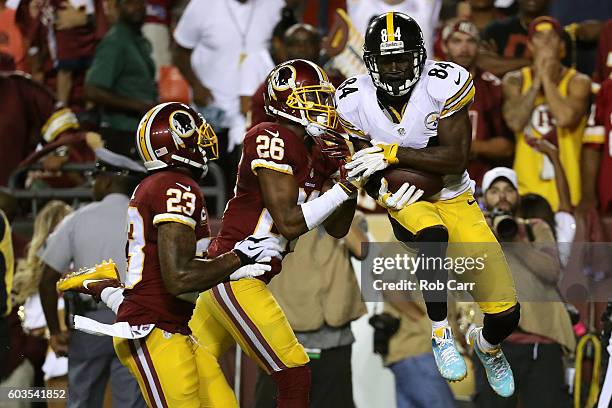 Wide receiver Antonio Brown of the Pittsburgh Steelers scores a second quarter touchdown past cornerback Bashaud Breeland and strong safety DeAngelo...