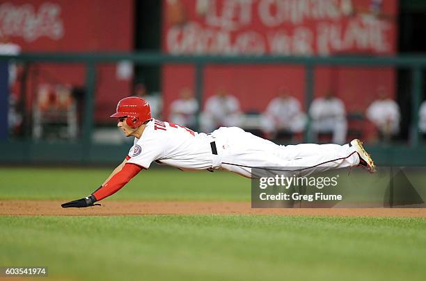 Trea Turner of the Washington Nationals steals second base in the first inning against the New York Mets at Nationals Park on September 12, 2016 in...