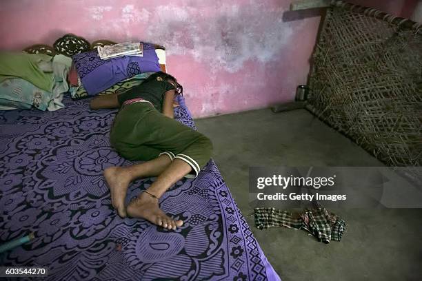 Year old Gitanjali sleeps in her bed on August 1, 2016 in Uttar Pradesh, India. Her 30 year old father sexually abused her for years and raped her...