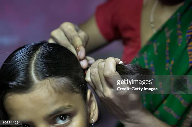 Year old Gitanjali has her hair done by her mother on August 1, 2016 in Uttar Pradesh, India. Her 30 year old father sexually abused her for years...