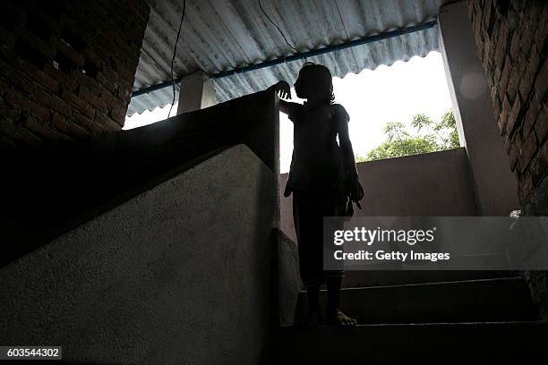 Year old Gitanjali poses in the stairwell in her home where she was raped by her father, on August 1, 2016 in Uttar Pradesh, India. Her 30 year old...