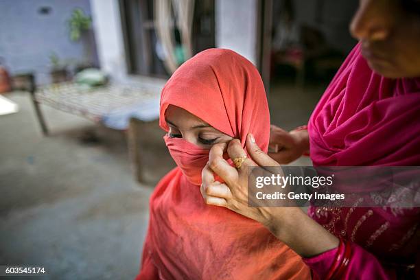 Year old Sadaf has her scarf adjusted by her aunt before she stands for a photo on September 8, 2016 in Uttar Pradesh, India. 3 months ago she was...