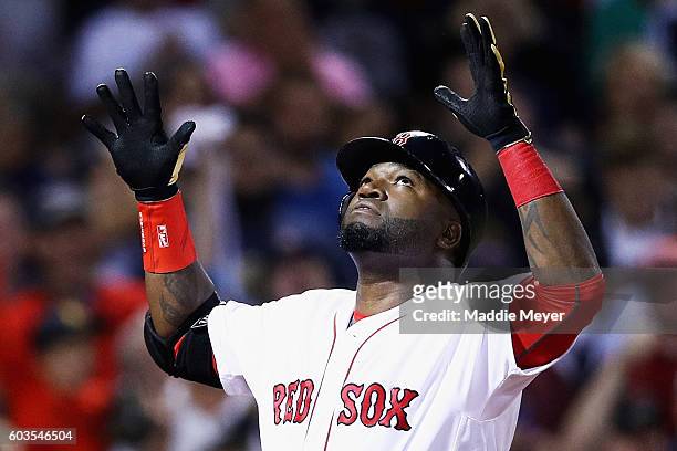 David Ortiz of the Boston Red Sox celebrates after hitting a home run against the Baltimore Orioles during the sixth inning at Fenway Park on...