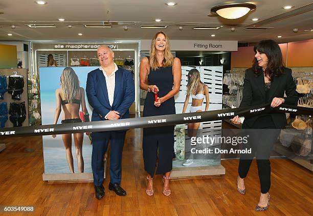 Elle Macpherson cuts the ribbon as Simon De Winter and Gillian Ridley Whittle look on during the launch of "Elle Macpherson Body" at Myer Sydney on...