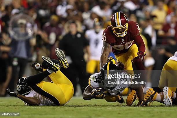 Running back DeAngelo Williams of the Pittsburgh Steelers carries the ball against defensive back David Bruton of the Washington Redskins in the...