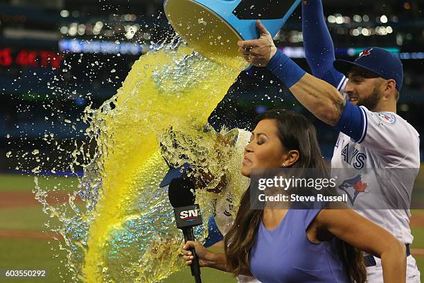 SportsNet reporter Hazel Mae narrowly avoids getting caught in a Powerade shower that Kevin Pillar gave to game hero Ezequiel Carrera as the Toronto...